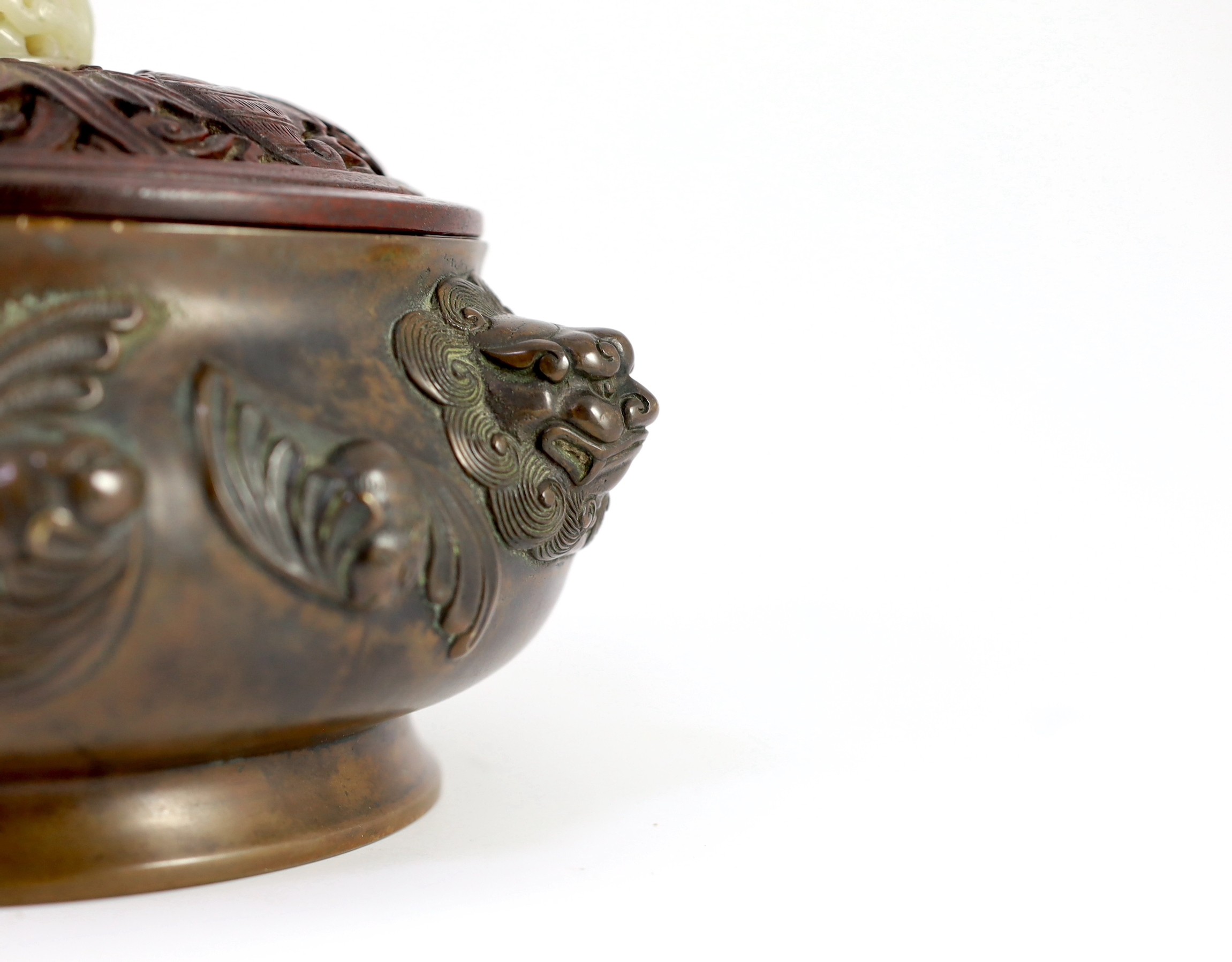 A large Chinese bronze ding censer, the wood cover with pale celadon jade finial, 22cm across